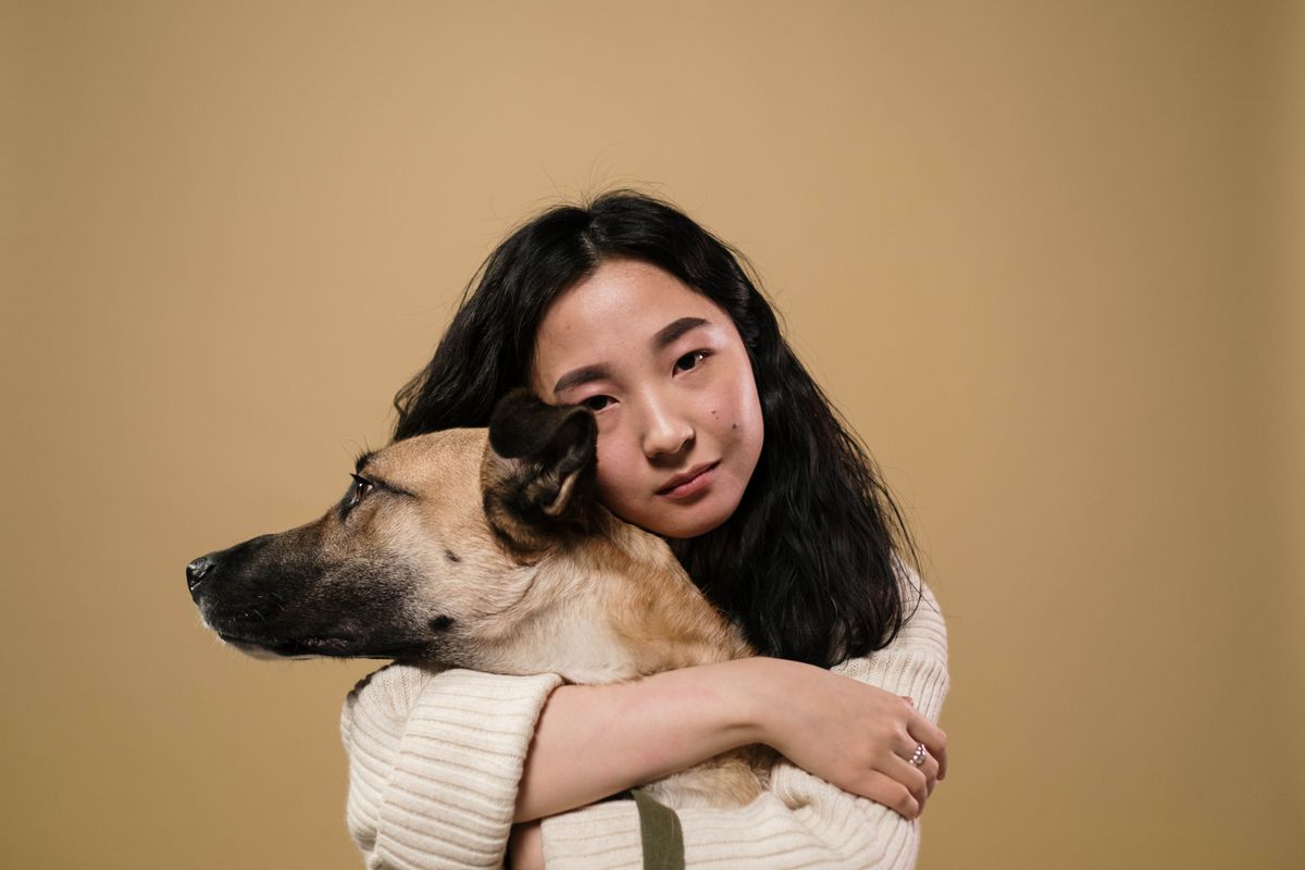A woman embracing her dog